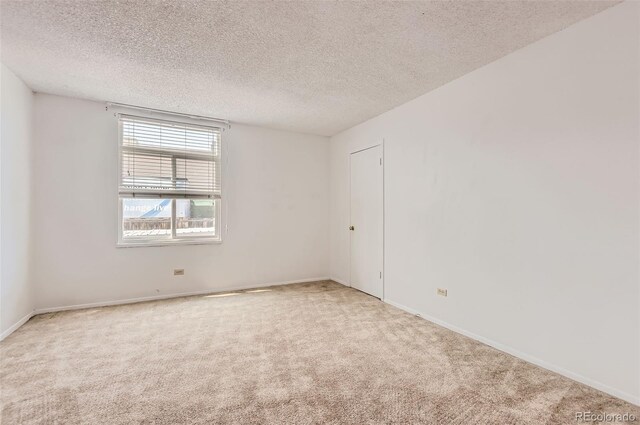 3436 S Locust St Unit D, Denver, CO 80222 - empty room with carpet floors, a textured ceiling, and baseboards