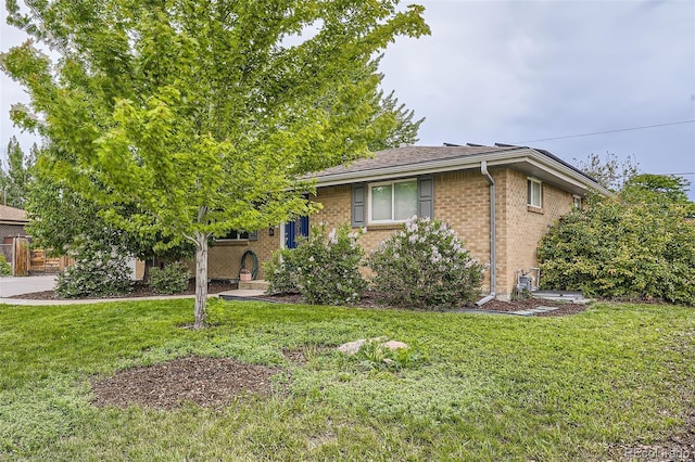 6046 Vrain St, Arvada, CO 80003 - view of front of home featuring brick siding and a front lawn