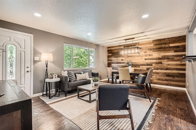 6046 Vrain St, Arvada, CO 80003 - living area with a textured ceiling, wood walls, baseboards, dark wood-style floors, and recessed lighting