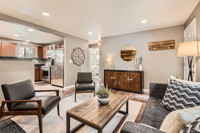 6046 Vrain St, Arvada, CO 80003 - living room with light wood finished floors, recessed lighting, and baseboards