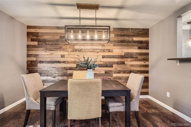 6046 Vrain St, Arvada, CO 80003 - dining room with wood walls, dark wood-type flooring, and baseboards