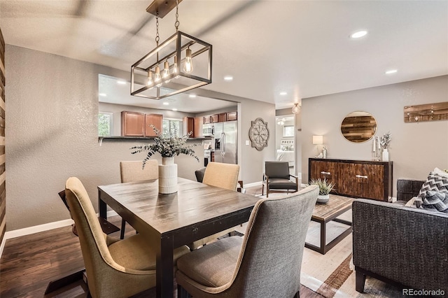 6046 Vrain St, Arvada, CO 80003 - dining room featuring wood finished floors, a textured wall, recessed lighting, plenty of natural light, and baseboards