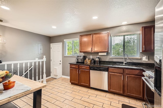 6046 Vrain St, Arvada, CO 80003 - kitchen featuring appliances with stainless steel finishes, a sink, recessed lighting, a textured ceiling, and light wood-type flooring