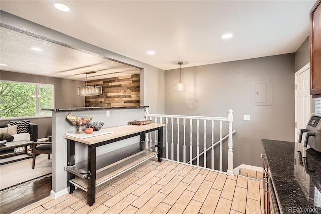 6046 Vrain St, Arvada, CO 80003 - kitchen with light wood-style floors, recessed lighting, decorative light fixtures, and dark stone counters