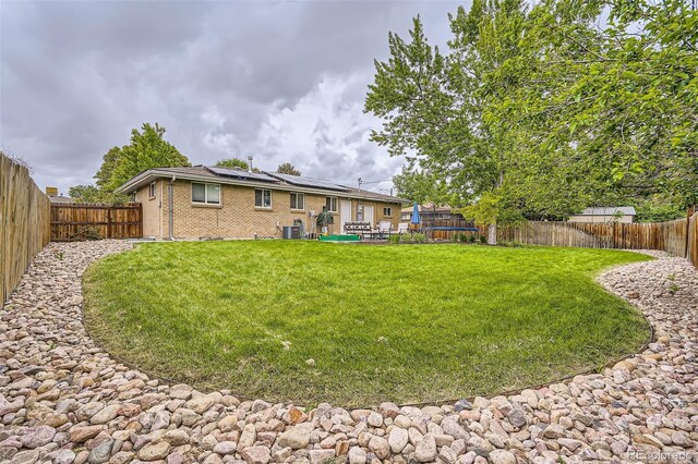 6046 Vrain St, Arvada, CO 80003 - view of yard featuring a trampoline and central AC