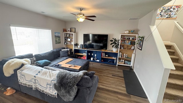 living room featuring visible vents, baseboards, a ceiling fan, stairway, and wood finished floors