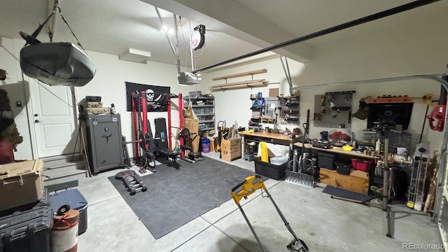 garage featuring a workshop area and a garage door opener