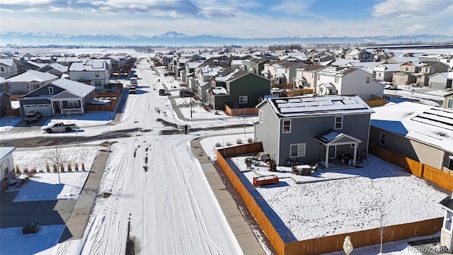 snowy aerial view with a residential view