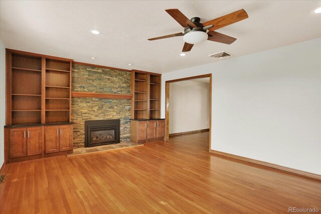 unfurnished living room with a fireplace, light wood-type flooring, recessed lighting, baseboards, and a ceiling fan