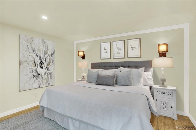 bedroom with baseboards, light wood-style flooring, and recessed lighting