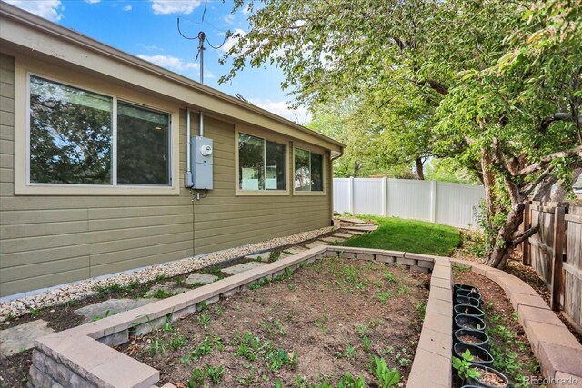 view of home's exterior featuring a fenced backyard and a garden