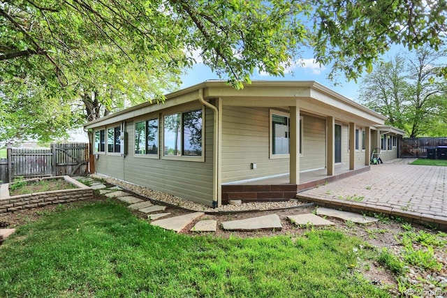 view of side of property featuring a patio area