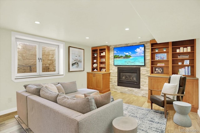 7895 W 67th Ave, Arvada, CO 80004 - living room featuring wood finished floors, a fireplace, baseboards, recessed lighting, and built in shelves