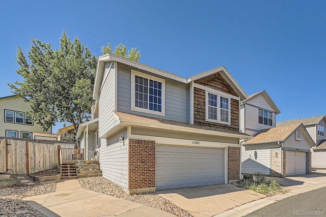 10440 W 83rd Ave, Arvada, CO 80005 - view of front of property with fence, concrete driveway, a garage, and brick siding