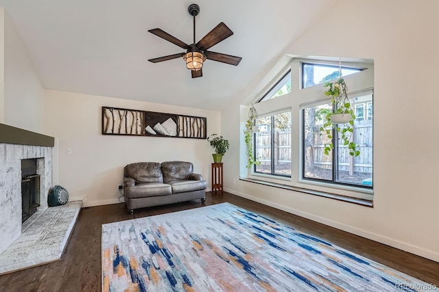 10440 W 83rd Ave, Arvada, CO 80005 - living room featuring ceiling fan, a fireplace, wood finished floors, baseboards, and high vaulted ceiling