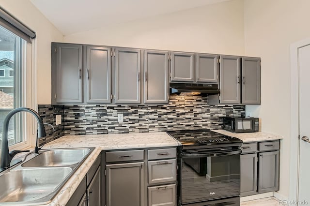 10440 W 83rd Ave, Arvada, CO 80005 - kitchen with a sink, gray cabinets, under cabinet range hood, vaulted ceiling, and black appliances