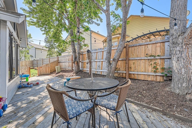 10440 W 83rd Ave, Arvada, CO 80005 - wooden terrace with outdoor dining area and a fenced backyard