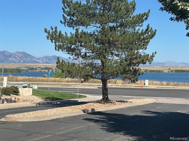 10440 W 83rd Ave, Arvada, CO 80005 - view of road with a water and mountain view, curbs, and sidewalks