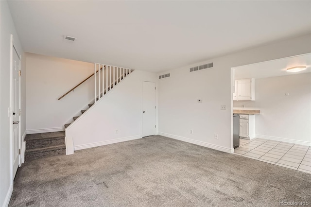 unfurnished living room featuring light colored carpet