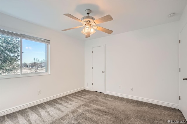 carpeted spare room with ceiling fan