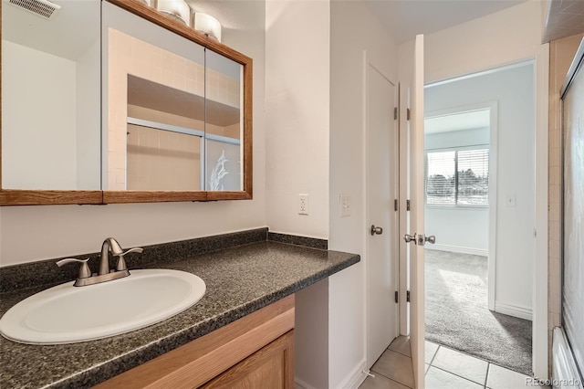 bathroom with tile patterned floors and vanity