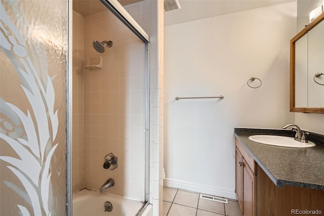 bathroom with tiled shower / bath, tile patterned floors, and vanity