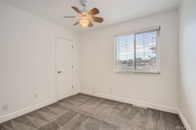 carpeted spare room with ceiling fan