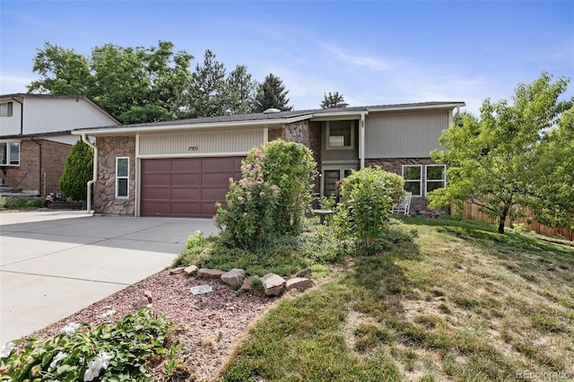 7951 S Webster Way, Littleton, CO 80128 - view of front facade featuring stone siding, concrete driveway, an attached garage, and a front lawn