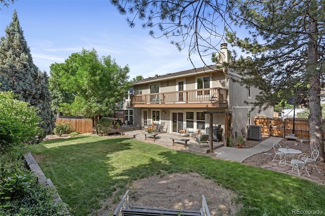 7951 S Webster Way, Littleton, CO 80128 - rear view of property featuring a patio, a chimney, and a wooden deck