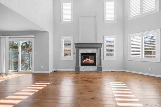 unfurnished living room featuring dark hardwood / wood-style flooring and a high ceiling