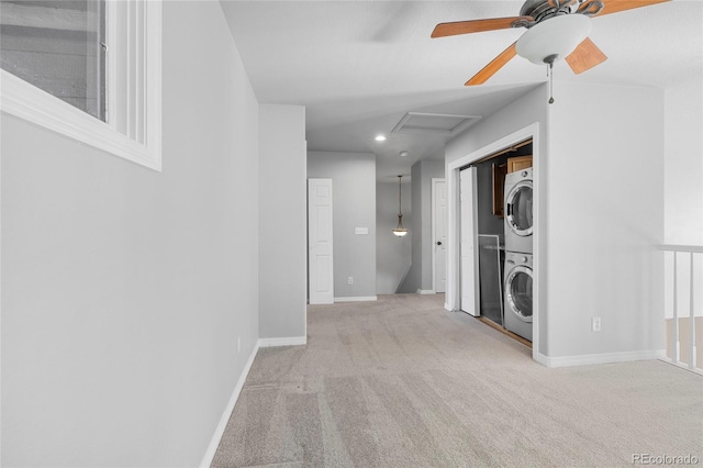 washroom with stacked washer and clothes dryer and light carpet