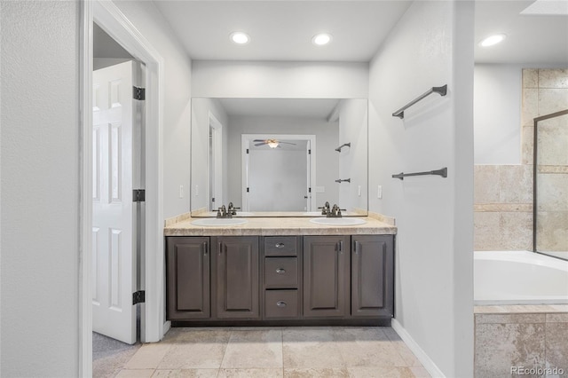 bathroom featuring ceiling fan, vanity, and separate shower and tub