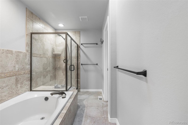 bathroom featuring tile patterned flooring and separate shower and tub