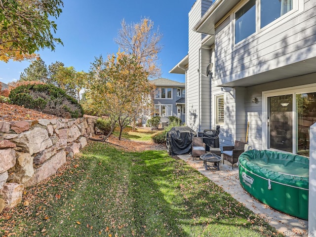 view of yard with a patio and a fire pit