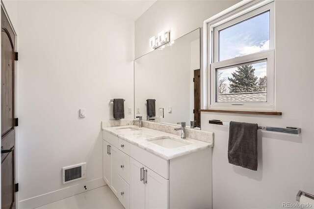 6102 S Aberdeen St, Littleton, CO 80120 - full bathroom with double vanity and baseboards