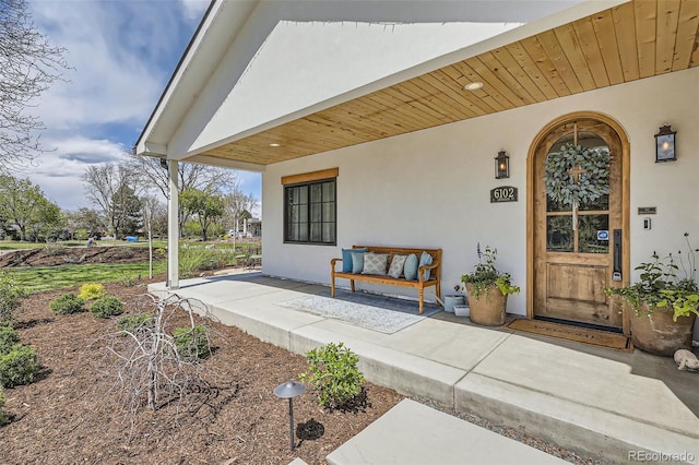 6102 S Aberdeen St, Littleton, CO 80120 - entrance to property featuring covered porch and stucco siding