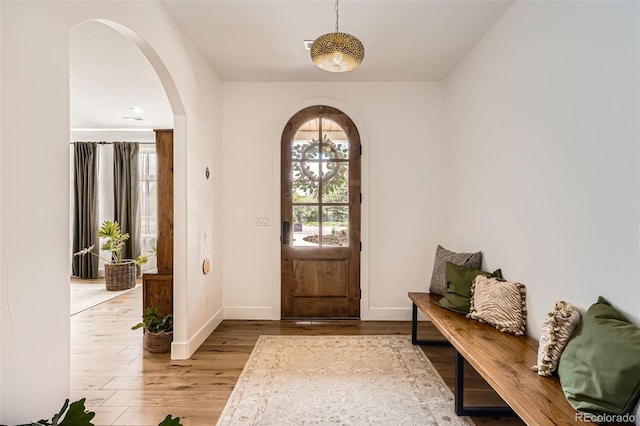 6102 S Aberdeen St, Littleton, CO 80120 - entryway featuring arched walkways, wood finished floors, and baseboards