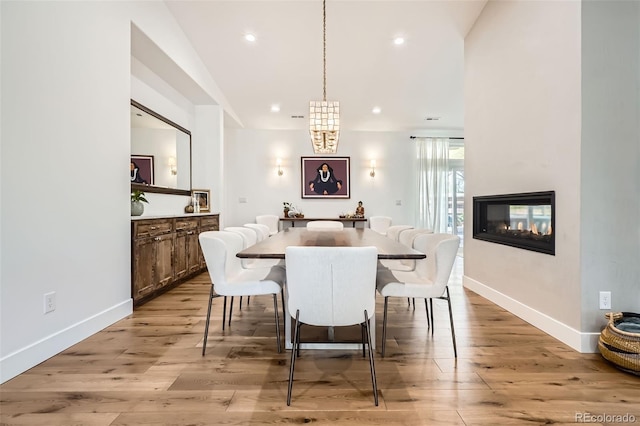 6102 S Aberdeen St, Littleton, CO 80120 - dining space with baseboards, light wood-type flooring, a multi sided fireplace, and recessed lighting