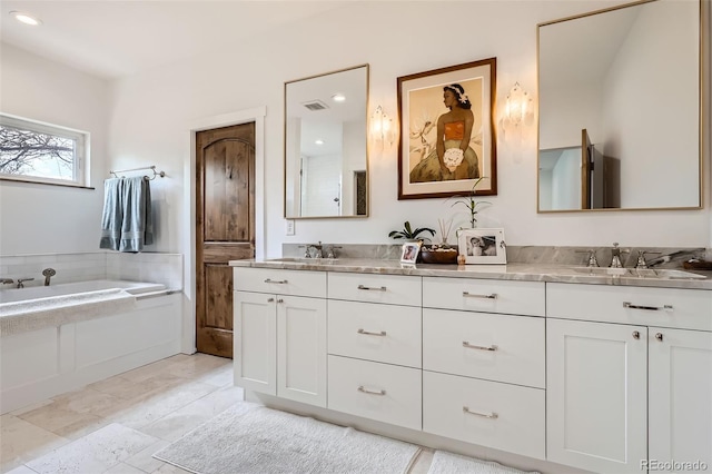6102 S Aberdeen St, Littleton, CO 80120 - full bath with double vanity, a garden tub, and recessed lighting