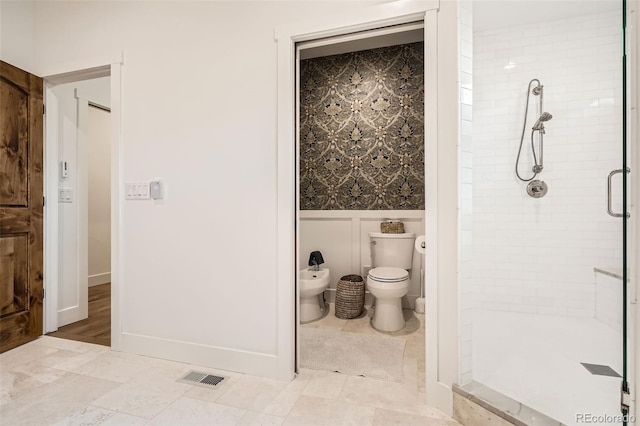 6102 S Aberdeen St, Littleton, CO 80120 - bathroom with a shower stall, a bidet, wainscoting, toilet, and a decorative wall