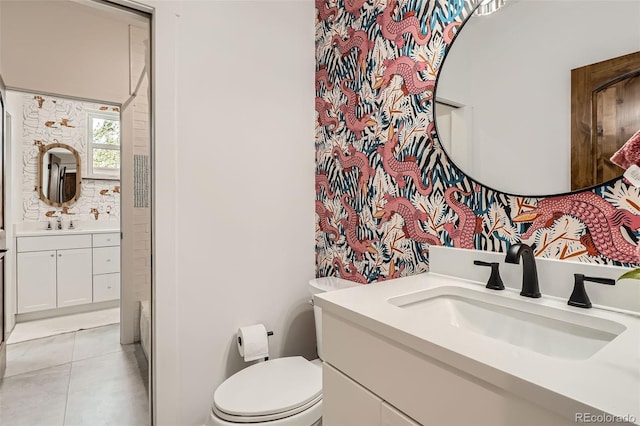 6102 S Aberdeen St, Littleton, CO 80120 - full bathroom with toilet, two vanities, and tile patterned floors