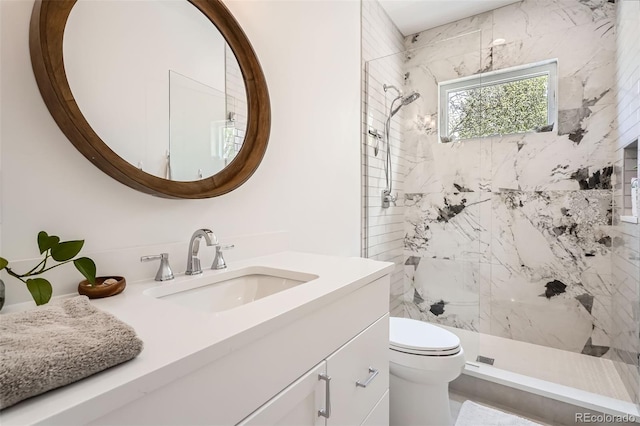 6102 S Aberdeen St, Littleton, CO 80120 - bathroom featuring toilet, tiled shower, and vanity