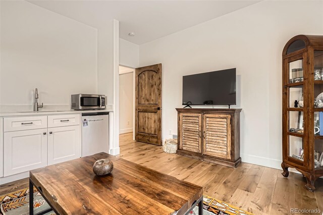 6102 S Aberdeen St, Littleton, CO 80120 - living room with light wood finished floors and baseboards