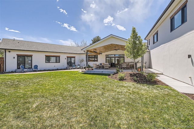 6102 S Aberdeen St, Littleton, CO 80120 - rear view of house with stucco siding, an outdoor hangout area, a patio area, and a lawn
