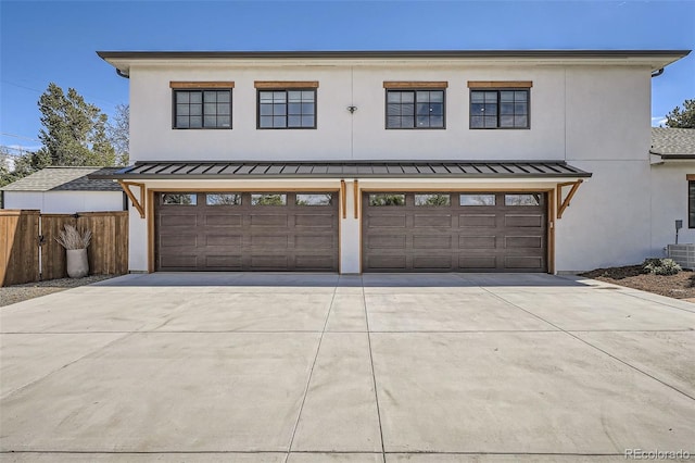 6102 S Aberdeen St, Littleton, CO 80120 - view of front of house with a standing seam roof, driveway, fence, and an attached garage