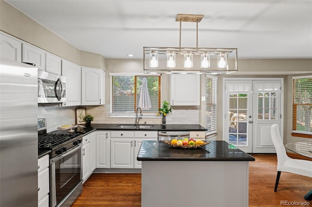 20922 E Crestline Cir, Centennial, CO 80015 - kitchen featuring stainless steel appliances, a sink, dark countertops, white cabinets, and recessed lighting