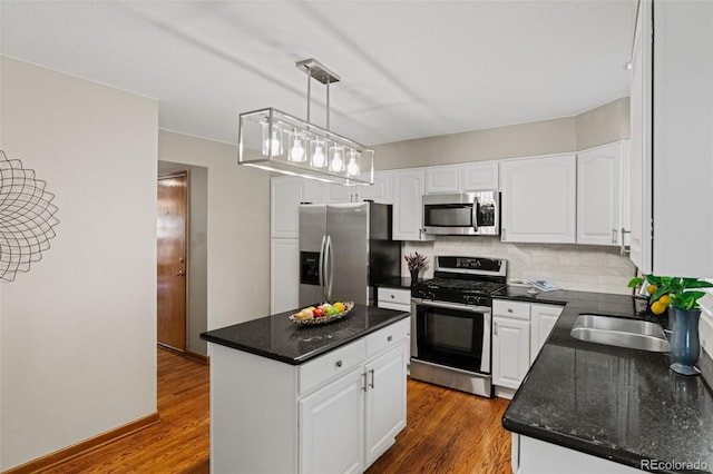 20922 E Crestline Cir, Centennial, CO 80015 - kitchen featuring stainless steel appliances, white cabinetry, a center island, a sink, and dark wood-style floors