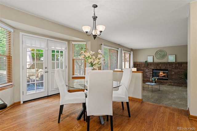 20922 E Crestline Cir, Centennial, CO 80015 - dining room featuring plenty of natural light, wood finished floors, a fireplace, and baseboards