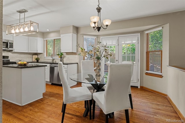 20922 E Crestline Cir, Centennial, CO 80015 - dining room featuring a chandelier, light wood-type flooring, and baseboards