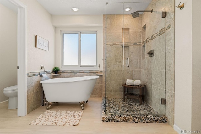 20922 E Crestline Cir, Centennial, CO 80015 - bathroom with a stall shower, a freestanding tub, toilet, and wood finished floors